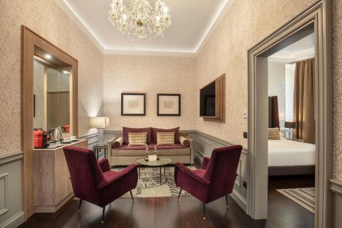a living room with a couch and two chairs at The Inn at the Spanish Steps Luxury Collection - The Inn at the Spanish Steps in Rome