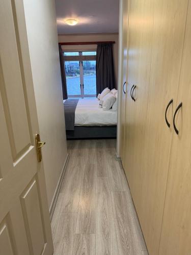 a door to a bedroom with a bed and a window at La Caribe Unit 01 in Jeffreys Bay