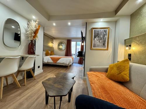 a living room with a couch and a bed at Hotel Nation Montmartre in Paris