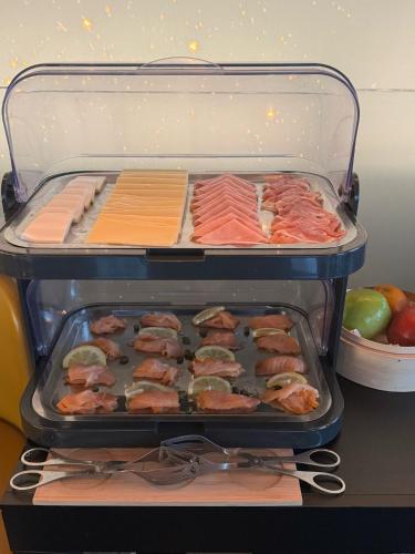 a container of food with salmon and other foods at Golden Lisbon Hotel in Lisbon