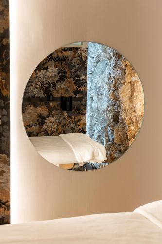 a mirror on the wall of a bedroom at Hotel Balneario La Hermida in La Hermida