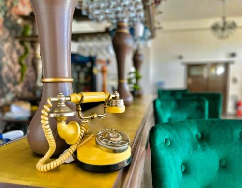 a yellow phone sitting on top of a table at Riviera 990 - Resort & Restaurant in Eşelniţa