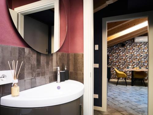 a bathroom with a sink and a mirror at Ca' Martini Apartments in Peschiera del Garda