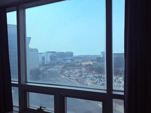 a view of a city from an office window at Incheon Airport Stay Guesthouse in Incheon