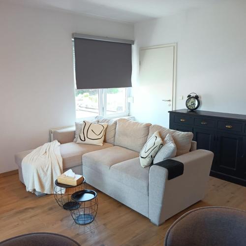 a living room with a couch and a table at InContri in Liège