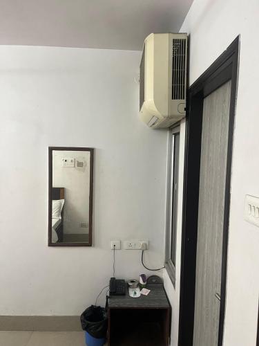 a room with a table with a mirror and a television at Hotel Ananda in Bokāro
