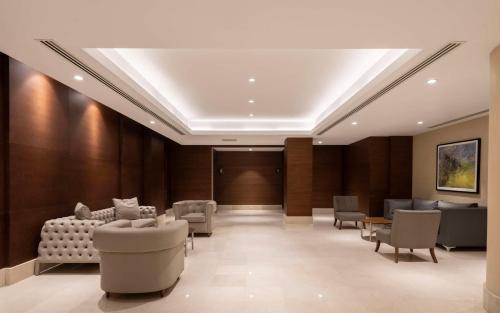 a waiting room with couches and chairs in a building at Radisson Blu Hotel Ankara Cankaya in Ankara