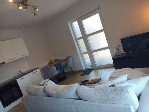 a living room with a white couch and a window at InContri in Liège
