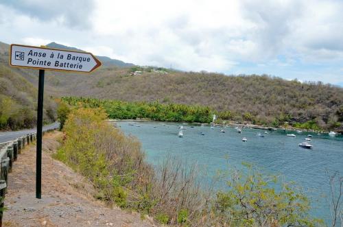 a sign on the side of a river with boats at Bèl Péyi - Bas de Villa T4 Proche de la Plage in Bouillante