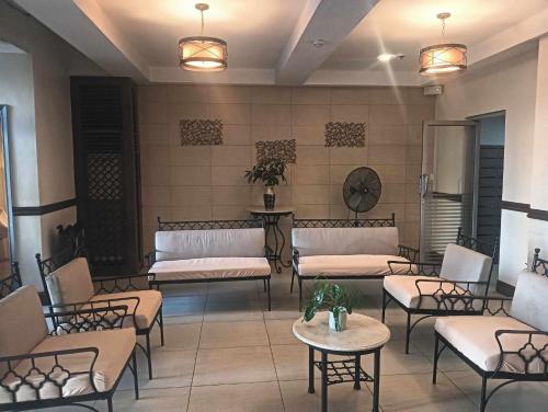 a waiting room with couches and tables in a building at Xian's place Budget Friendly Condo in Manila