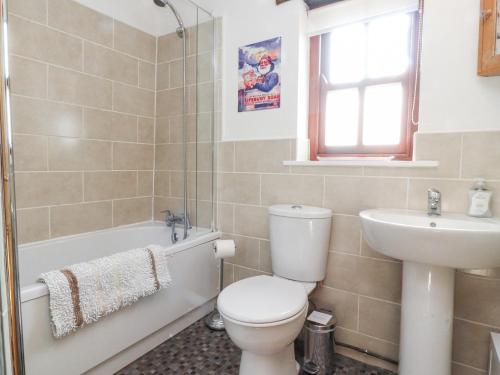 a bathroom with a toilet and a sink at Mallards Nest in Skipton