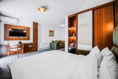 a hotel room with a bed and a desk at Alexander Resort in Sopot