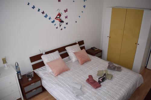 a bedroom with a bed with shoes on it at L’orchidée SPA Apartment in Breitenbach