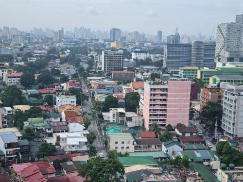 a city with tall buildings and buildings at Newly Furnished Condominium in the Heart of Quezon City near Top Philippine Hospitals in Manila