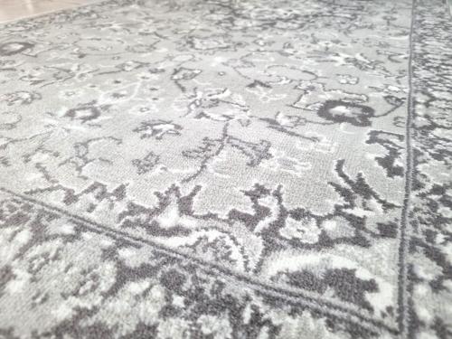 a rug with a drawing of animals on it at Newly Furnished Condominium in the Heart of Quezon City near Top Philippine Hospitals in Manila