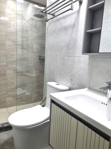 a bathroom with a toilet and a sink and a shower at Newly Furnished Condominium in the Heart of Quezon City near Top Philippine Hospitals in Manila