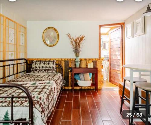 a bedroom with a bed and a table at Tiny House surrounded by Florida farm beauty in Arcadia