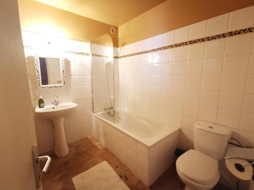 une salle de bain avec toilettes, lavabo et baignoire dans l'établissement Maison Figue, maison de village Aspiran, l'Hérault, à Aspiran
