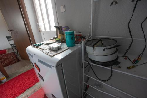 a white refrigerator with a pot on top of it at 1971 Apart in Gusinje