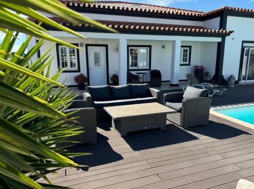 a patio with a table and chairs next to a pool at Spacious quiet charming villa with private pool and close to Lisbon in Monte de Lucas