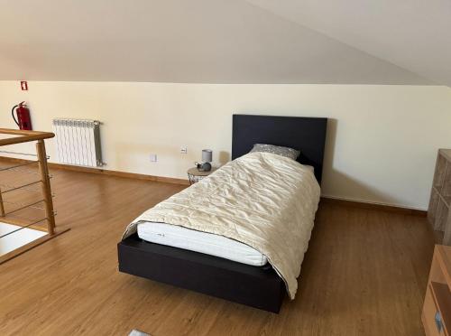 a bedroom with a bed with a black headboard at Spacious quiet charming villa with private pool and close to Lisbon in Monte de Lucas
