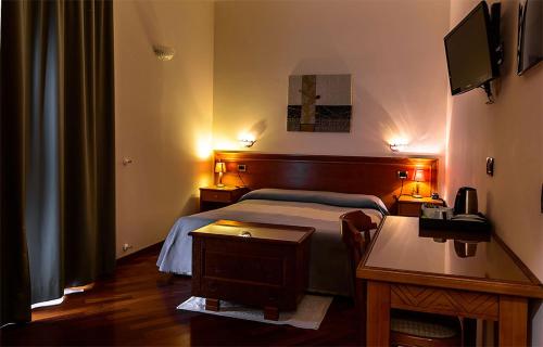 Postel nebo postele na pokoji v ubytování Hotel Del Corso
