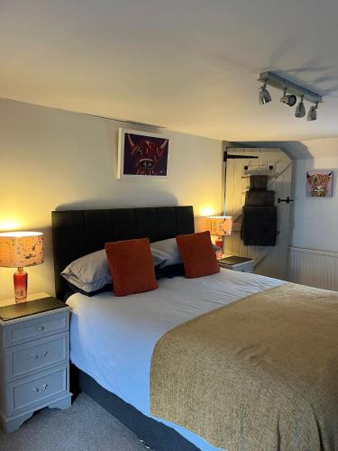 a bedroom with a bed with two pillows on it at Dunnottar Cottage in Stonehaven