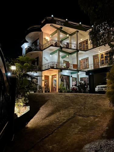 a large building at night with its lights on at ABC Guest Inn & Restaurant in Haputale