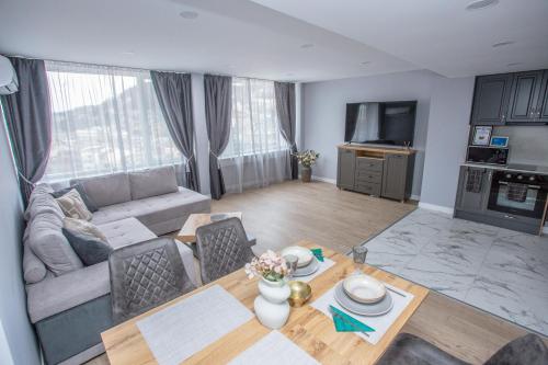 a living room with a couch and a table at Balkan Tower Deluxe Ultra in Gabrovo