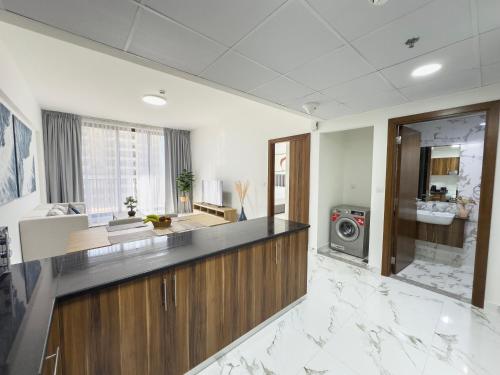 a large kitchen with a counter and a sink at Marina Residences Al Hamra Village in Ras al Khaimah