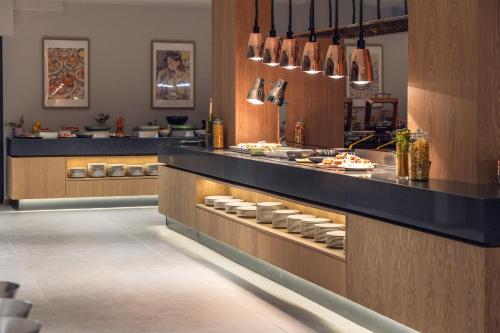 a kitchen with a counter with plates of food at Kamengrad Hotel & SPA in Panagyurishte