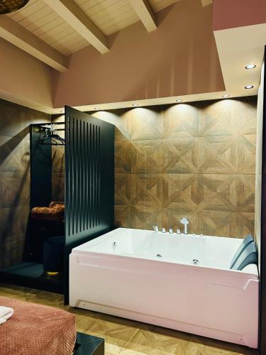 a bathroom with a large tub in a room at Spera Luxury Palermo & SPA in Palermo