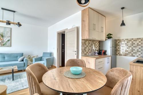 a kitchen and living room with a wooden table and chairs at Vila Jezero 2 in Žabljak