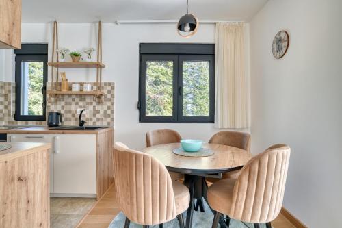 a kitchen and dining room with a table and chairs at Vila Jezero 2 in Žabljak