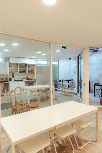 a dining room and kitchen with a table and chairs at Arca Nova Guest House - Caminha in Caminha