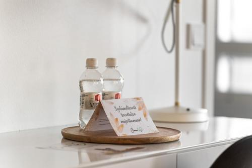 two bottles of water sitting on top of a counter at Come in! "Ilmatar" Luxury apartments in the heart of Tampere with yacuzzi option! in Tampere