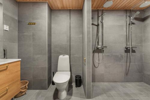 a bathroom with a toilet and a shower at Come in! "Ilmatar" Luxury apartments in the heart of Tampere with yacuzzi option! in Tampere