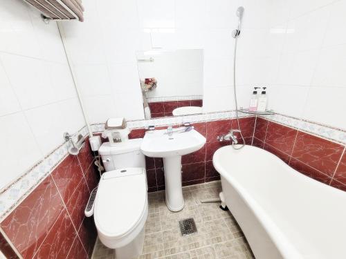 a bathroom with a toilet and a sink and a tub at Sweet House in Seoul