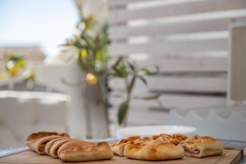 three types of bread sitting on a table at Dea's Rooms in Noto