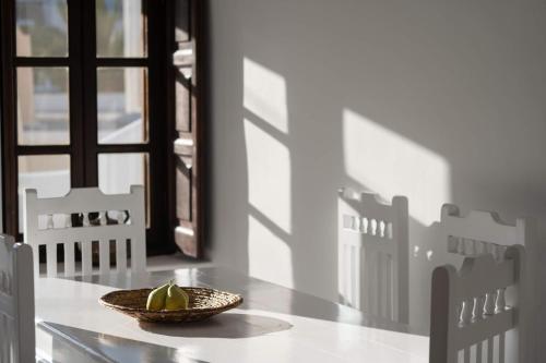 a bowl of fruit sitting on a table with a window at Kalitsi Canaves in Vóthon