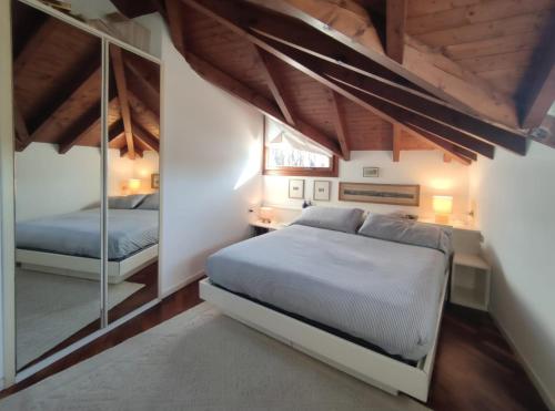a bedroom with a bed and a mirror in it at La casa di Giò in Angera