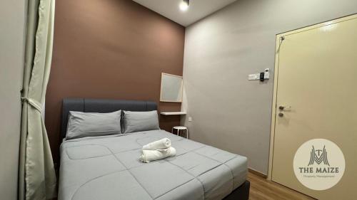 a small room with a bed with a stuffed animal on it at Verdant Sunset The Cove Ipoh in Ipoh