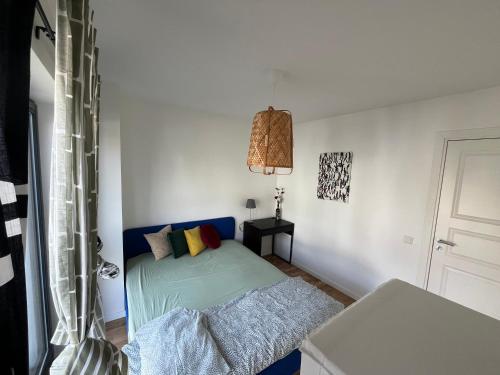a small bedroom with a bed and a lamp at Guest room with private bathroom in Åkersberga