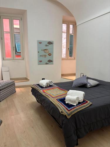 a bedroom with a bed with two towels on it at Casa Luna in Ventimiglia