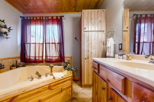 a bathroom with a large tub and a sink at Golfview Lodge in New Rome