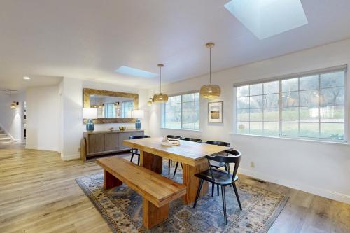 a dining room with a wooden table and chairs at Whispering Oaks Estate in Murphys