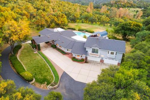 an aerial view of a house with a swimming pool at Whispering Oaks Estate in Murphys