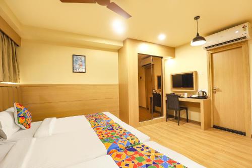 a hotel room with a bed and a desk at FabHotel Nestlay Rooms High Court - Nr Parry's Corner in Chennai