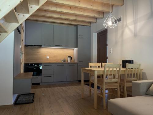 a kitchen and dining room with a table and chairs at Słoneczne tarasy in Życiny