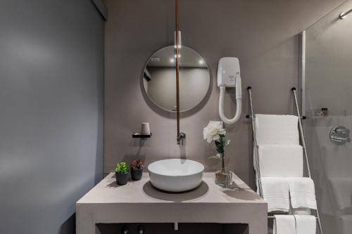 a bathroom with a sink and a mirror at Dea's Rooms in Noto